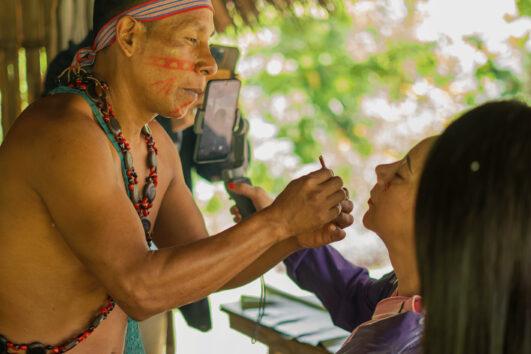 painting womens faces in Shuar culture scaled